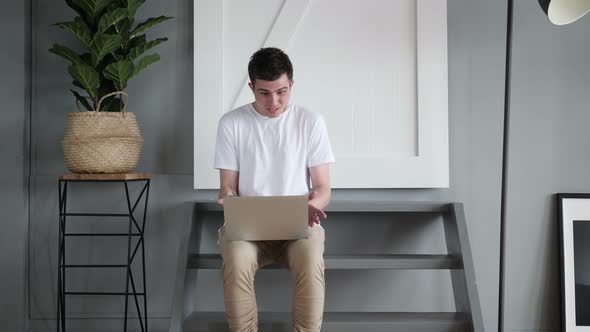 Working Man Reacting to Loss while Sitting on stairs