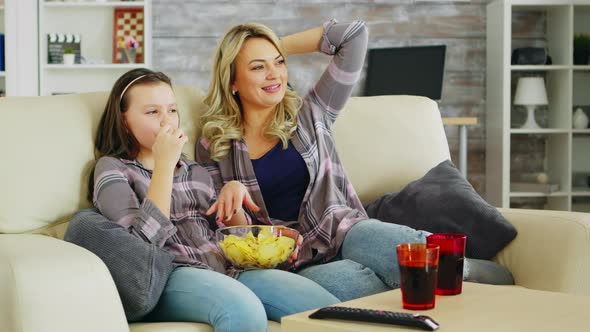 Little Girl Eating Chips While Watching Movie on Tv