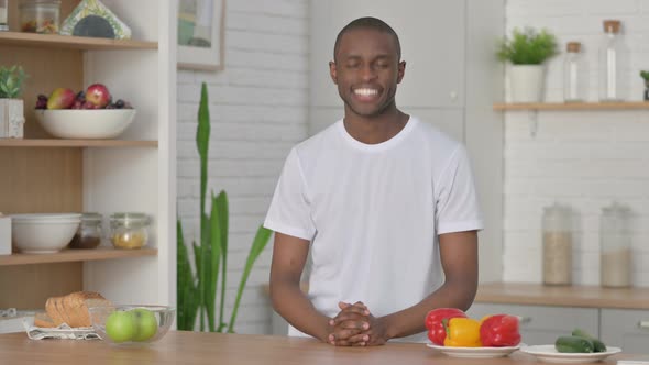 Sporty African Man Shaking Head As Yes Sign While in Kitchen