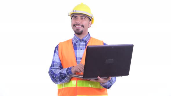 Happy Bearded Persian Man Construction Worker Thinking While Using Laptop