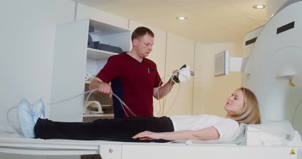 The Doctor Preparing Young Patient for an MRI Scan in a Modern Clinic