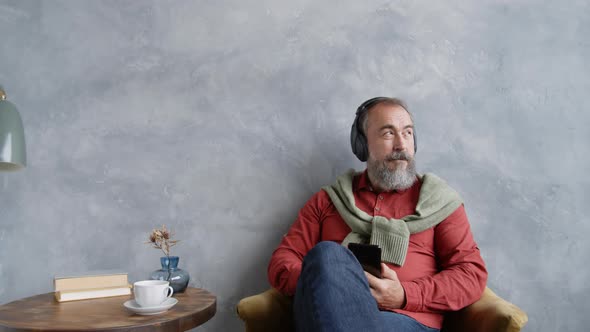 Aged Man Enjoying Music at Home