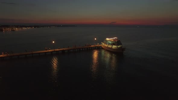 Aerial View of Pontoon on the Sea and People Walking on It From Cruise Boat at the Evening, Greece