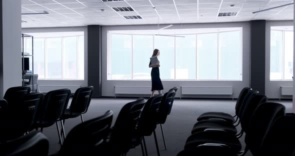 Silhouette of Young Business Woman Walking in Office Hall Corridor. Serious Attractive Female Goes