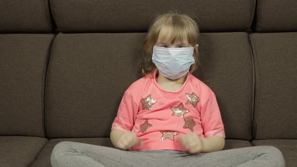 Concept of Sick Little Girl Wearing a Medical Mask. Quarantine. Coronavirus