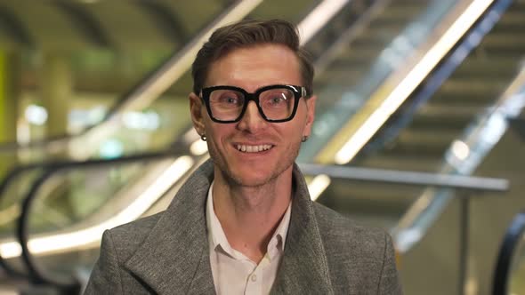 Face Portrait of an Yang Attractive Man with Glasses Hipster Slyle Looks Into the Camera and Smiles