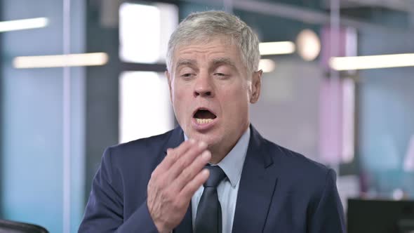 Portrait of Middle Aged Businessman Having Yawn