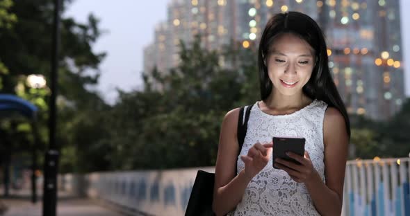 Woman use of smart phone at night 