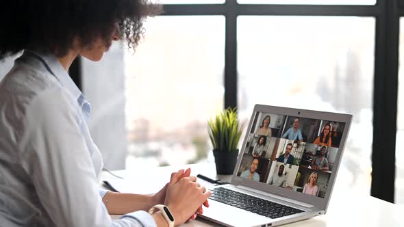 A Young Biracial Woman Is Using a Laptop for Video Connection Indoor