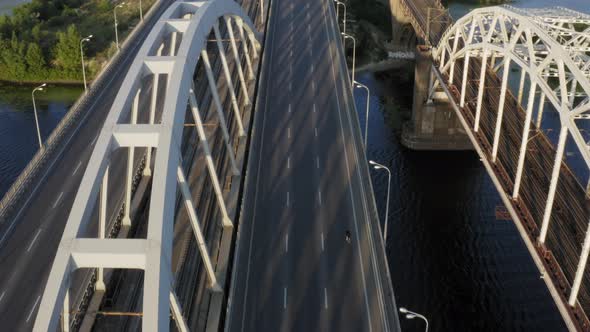 Aerial drone view of cyclist riding over the bridge