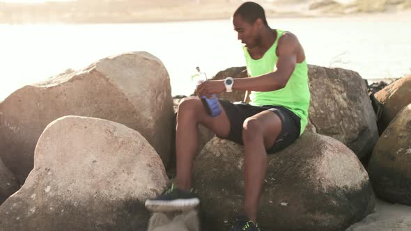 Man drinking water on the beach