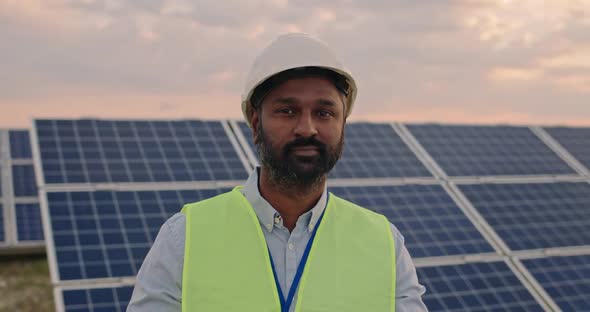 Portrait of Mixed Raced Engineer in Protective Helmet Crossing Arms While Looking To Camera