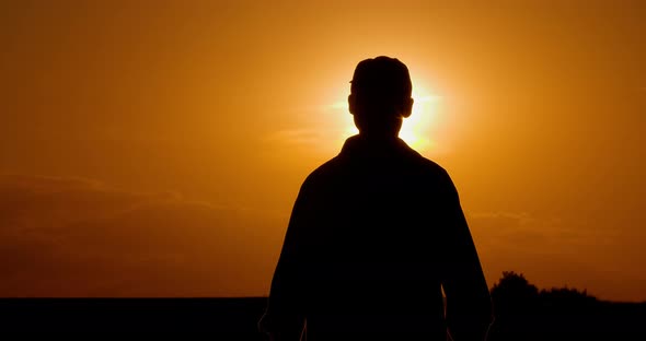 Farmer Using Digital Tablet at Farm Against Sunset