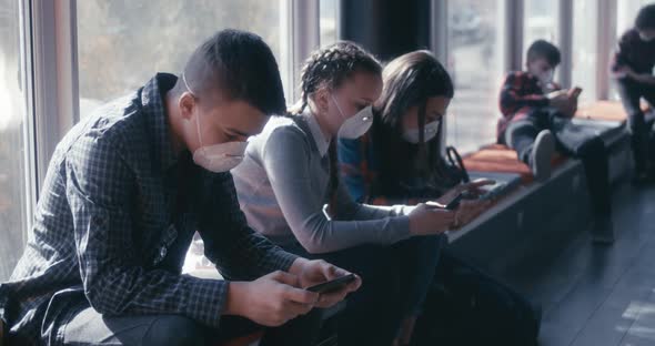 Face Mask Wearing Students Using Smartphone