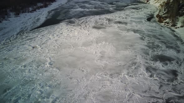 Calm Frozen River Covered with Ice on Cold Winter Day