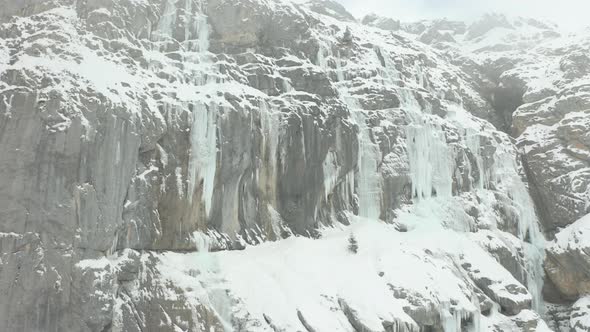 Jib up of large icicles hanging of mountain wall