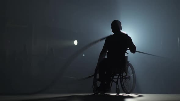 Disabled Man in Wheelchair Performs Exercises with Battle Ropes Endurance Training Gym Training and