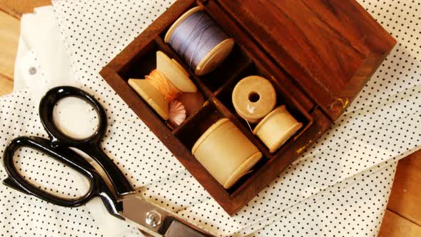 Close-up of thread roll in a box and scissor