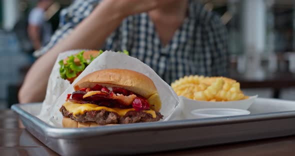 Woman enjoy burger and french fries