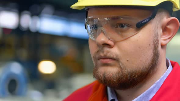 Handsome Engineer Walking in a Factory