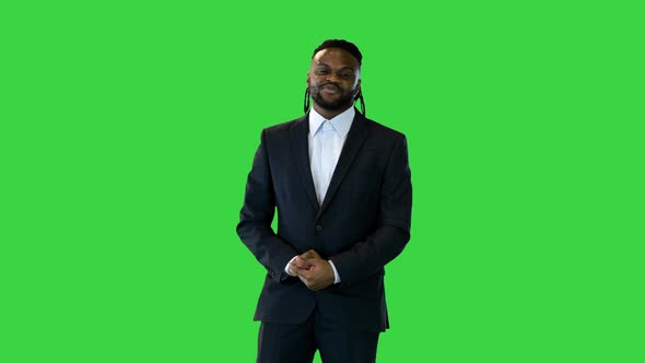 Black Man in Office Suit Telling Something in Front of Camera on a Green Screen Chroma Key
