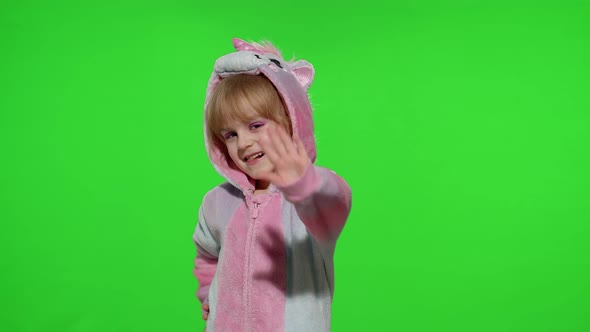 Little Child Girl Smiling Waving Greeting Hello or Bye with Hand in Unicorn Pajamas on Chroma Key