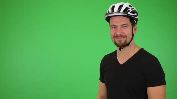 A Young Handsome Cyclist Smiles at the Camera - Green Screen Studio