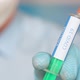 Close up of a researcher with face mask holding a syringe with coronavirus vaccine - VideoHive Item for Sale