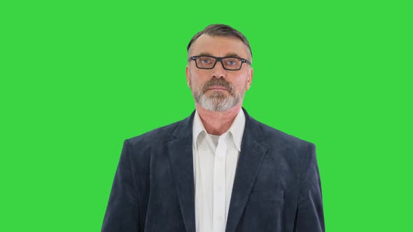 Senior Business Man Walking with Briefcase on a Green Screen Chroma Key