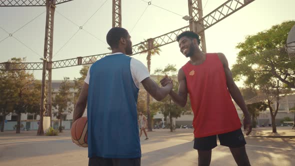 Cinematic footage of a street basketball game outdoor.