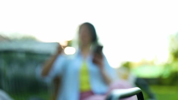 Happy Woman in Glasses Sitting on Chair at Backyard Outdoor at Home Take Lemonade