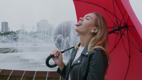 Lady Fooling Around in Rain Sticking Tongue Out