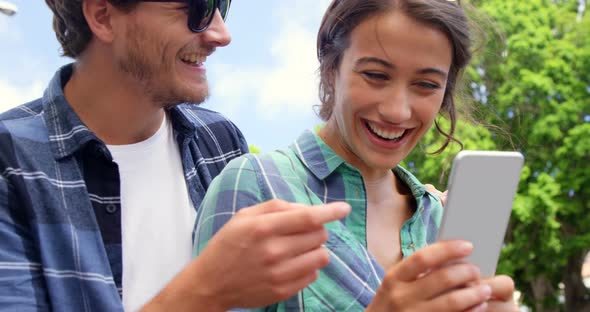 Friends using mobile phone alt