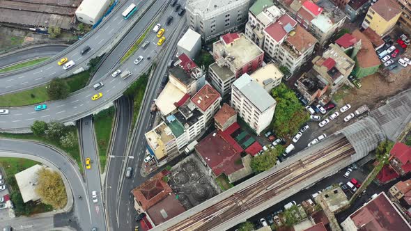 Aerial top down view of yellow taxi cabs crossing a interconnected highway loop surrounded by old Eu