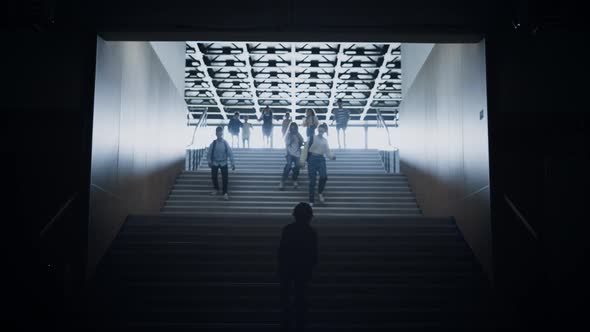 Teen Boy Going Up Through Children Crowd Running Downstairs