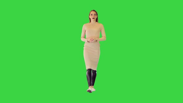 Robotic Girl in Beige Dress Walks Making a Slight Nod on a Green Screen Chroma Key