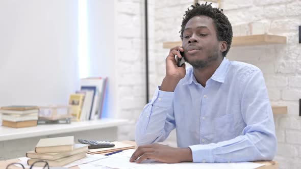 Working African Man Talking on Cellphone And Saying No