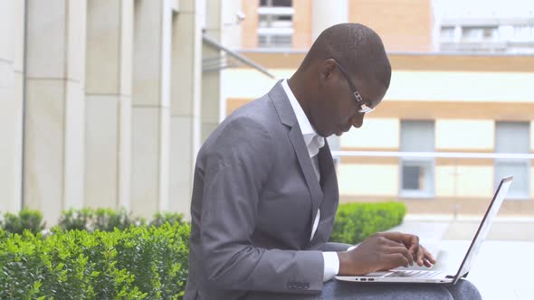 African American Entrepreneur Displaying Computer Laptop On. Outdoors