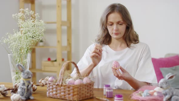 Beautiful Woman Painting on Easter Egg