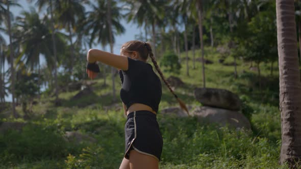 Athlete Girl Boxer Training Outside in the Fantastic Tropical Woods Healthy Lifestyle Concept