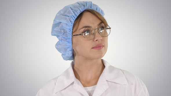 Woman doctor in glasses and hat walking and looking around