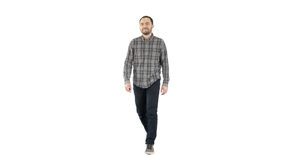 Young man walking in a good mood on white background.