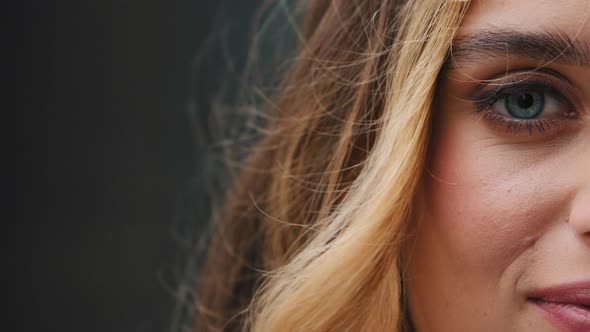 Closeup One Blue Female Eye Looks at Camera with Gaze with Beautiful Makeup