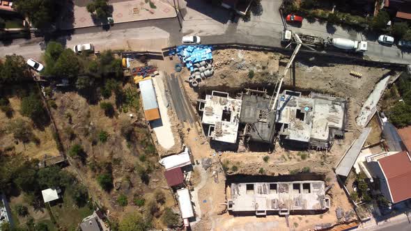 Fly Over the Construction Site Work As Construction Personnel Builders Work Construction Houses