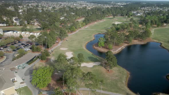 Beautiful Magnolia Greens Golf course aerial tracking backward