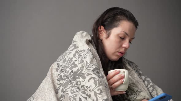 Portrait of Sick Tired Woman Patient with White Cup Sitting on Sofa