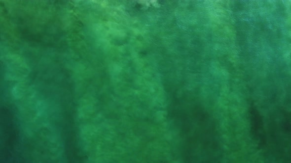 Abstract background. Ocean view from above - color seabed and sand under the waves.