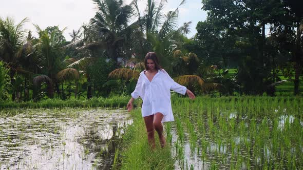 Tourist Woman is Walking on Rice Fields in Bali
