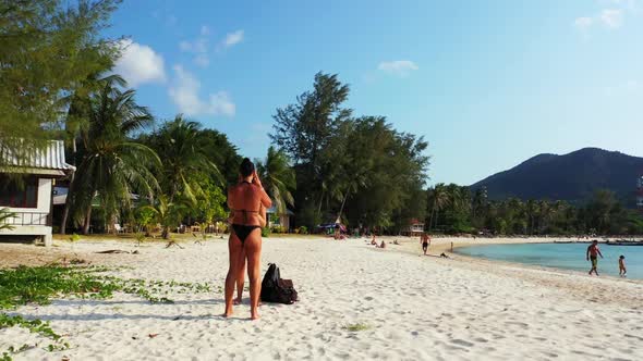 Ladies tanning on exotic bay beach voyage by shallow sea and white sandy background of Koh Phangan n