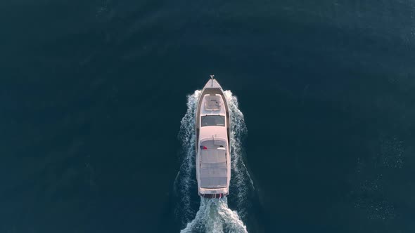 Powerboat Floats on the Blue Water of the Lake, Aerial View Slow Motion